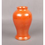 A Moorcroft orange lustre baluster shaped vase. Impressed mark, 15.25cm. Crazed. No damage or