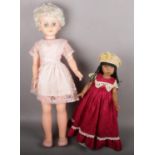 A large vintage doll in original clothing (74cm tall) along with along doll by Linda Rick.