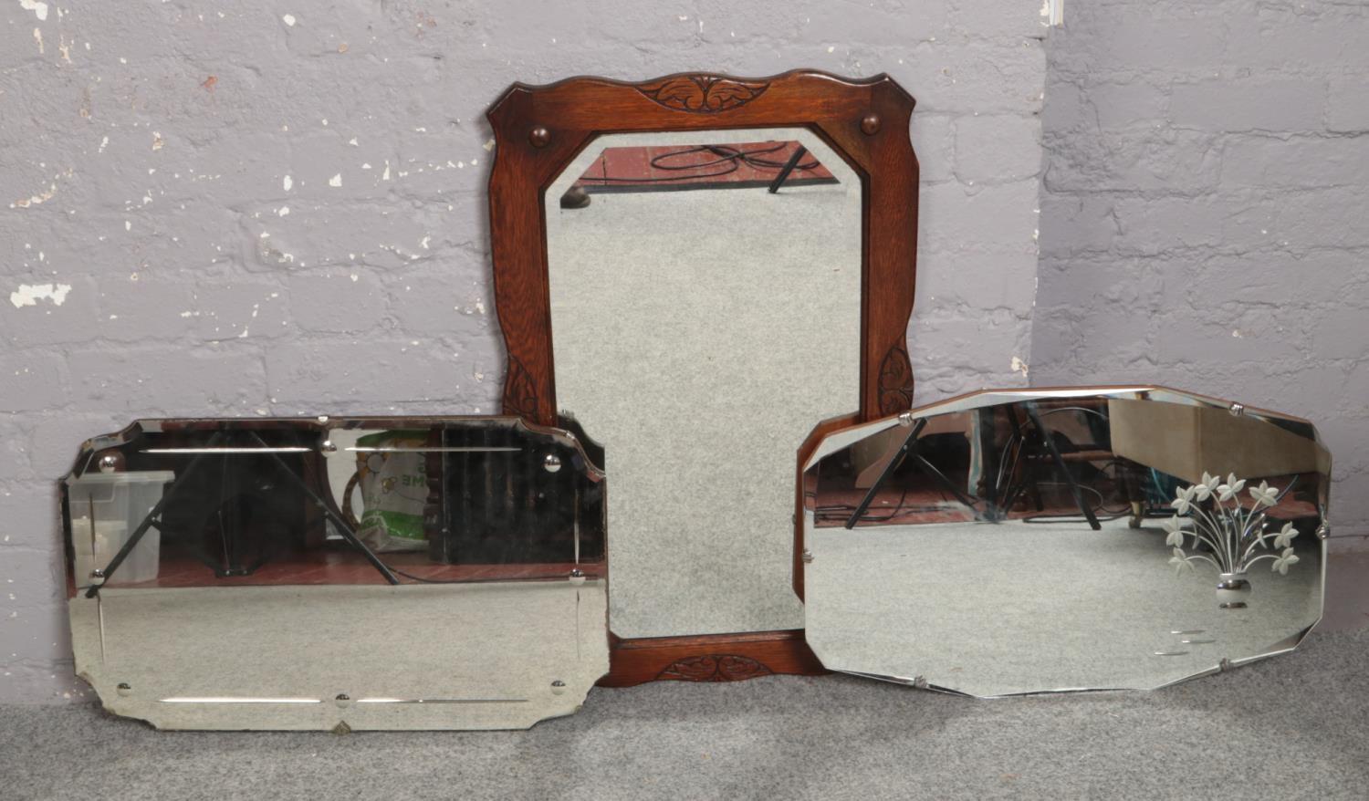 An oak frame bevel edge wall mirror, along with two vintage mirrors.