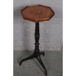 An octagonal tripod table with marquetry top.