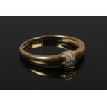 An 18ct gold ring set with a band of six diamonds. 2.15 grams gross. Size N.