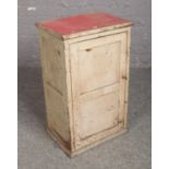 A vintage painted panelled cupboard.