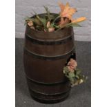 A Plastic Beer Barrel with Artificial flowers. Provenance; Lathom Hall Liverpool.