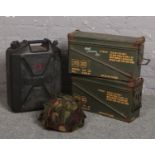 Two ammunition crates, a camouflaged 1985 Nato helmet and a plastic water carrier in the form of a