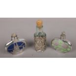 A silver mounted glass scent bottle with repousse decoration, assayed Birmingham 1911 along with two