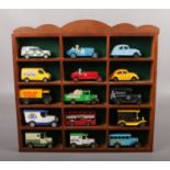 A wooden display with contents of diecast vehicles, to include Lledo, Corgi, Matchbox etc.