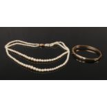 A two row graduated pearl necklace with 9ct gold clasp, 40cm. Along with a 9ct gold bangle with