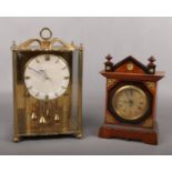 A brass cased Koma anniversary clock along with another German clock incorporating subsidiary