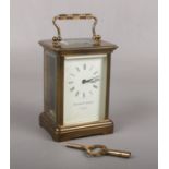 A brass cased carriage clock with platform escapement. Having enamel dial signed Matthew Norman,