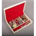 A jewellery box of costume jewellery to include white and coloured paste stone examples etc.