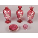 A collection of Victorian cranberry glass with Mary Gregory vases.