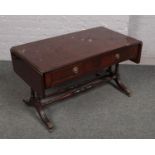 A mahogany drop leaf coffee table.