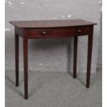 A Victorian mahogany bow front single drawer side table raised on square supports, 89cm wide, 44.5