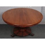 A Victorian mahogany breakfast table, raised on scroll feet support.