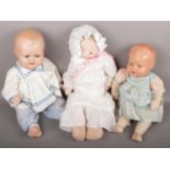 A Sugar Britches bisque head sleeping doll along with another doll marked HW JUBLIEE and one other