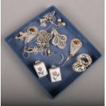 Ten pairs of silver earrings to include floral enamelled examples etc.