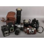 A box of cameras and photographic equipment. Including a Minolta SR-7 with Soligor 10-150mm zoom