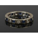 A 9ct gold eternity ring set with alternating blue and white paste stones, size K 1/2.