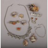 A small box of vintage costume jewellery to include rings, brooches, necklace etc.