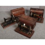 Three wooden cased hand crank sewing machines, to include Singer, Jones and one other.