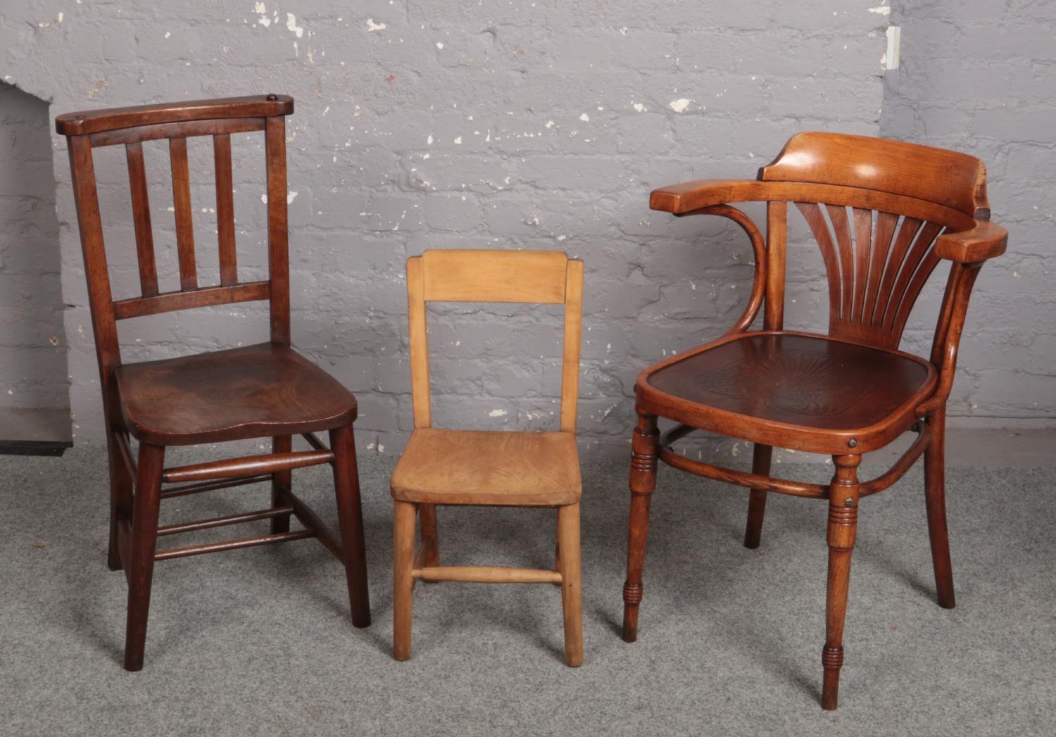 A 1920s bentwood armchair with fan patterned seat, a chapel chair and a childs chair.