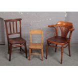 A 1920s bentwood armchair with fan patterned seat, a chapel chair and a childs chair.