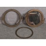 Two brass port holes, one later mirrored, 41cm diameter.