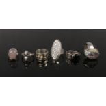 Six large silver dress rings including rock crystal, rose quartz and white past examples.