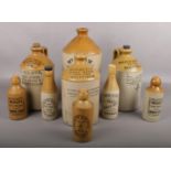 A collection of stoneware flagons and bottles, mostly Sheffield advertising examples.