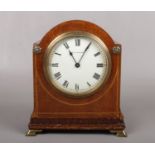 An Edwardian mahogany cased mantel clock with enamel dial signed Collingwood and raised on brass