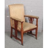 An Arts & Crafts inlaid mahogany upholstered armchair.