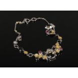 A silver necklace set with cabochon gemstones and mother of pearl. The links formed as honeycomb and