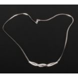 A 9ct white gold necklet on snake chain set with a row of graduating diamonds, 0.16ct, gross