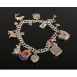 A silver charm bracelet with silver charms to include heart lock, animals etc, 21.7g.