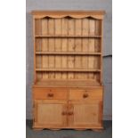 A Victorian pine kitchen dresser. 197cm high, 117cm wide, 42cm deep.