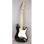 An Elevation electric guitar in Fender Stratocaster form. With maple neck, black finish and white