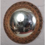 A gilt frame convex wall mirror (Diameter 48cm). Some chips to frame.