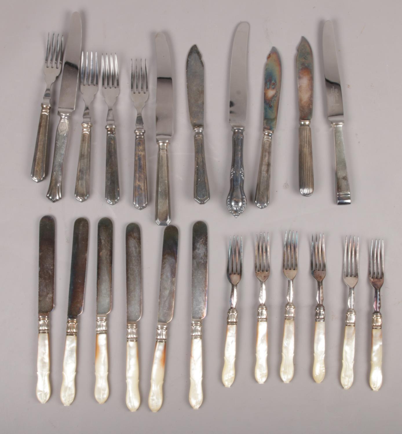 A quantity of silver plated cutlery including a set of tea knives and forks with carved mother of