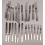 A quantity of silver plated cutlery including a set of tea knives and forks with carved mother of