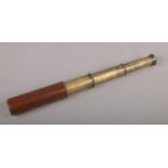 A Britannic brass and leather three drawer telescope.