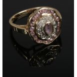 A 9ct gold diamond and pink stone ring, size N.