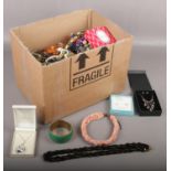 A large box of costume jewellery to include beads, necklaces, brooches, earrings etc.