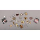 A collection of costume jewellery brooches.