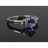 An Art Deco style 18ct white gold tanzanite and diamond ring. With an ovoid centre stone and