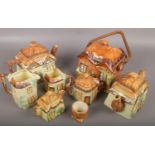 A group lot of ceramic cottageware to include teapot, swing handle biscuit jar, jug etc.