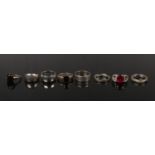 Six silver dress rings including faux ruby and hardstone examples.