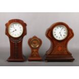 Three Edwardian mahogany cased mantel clocks, two inlaid. Each housing a French 8 day cylinder