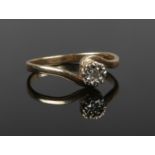 A 9ct gold diamond solitaire ring set on a scroll formed shank. Size M 1/2.