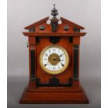 An oak cased 8 day automatic alarm clock by Fattorini & Sons. Bradford. With ebonized mouldings