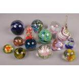 A collection of glass paperweights to include art glass examples etc.